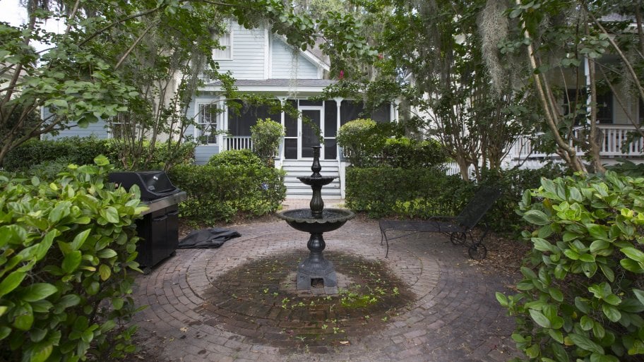 Backyard brick patio with fountain in Savannah, Georgia. Backyard brick patio with fountain in Savannah, Georgia.